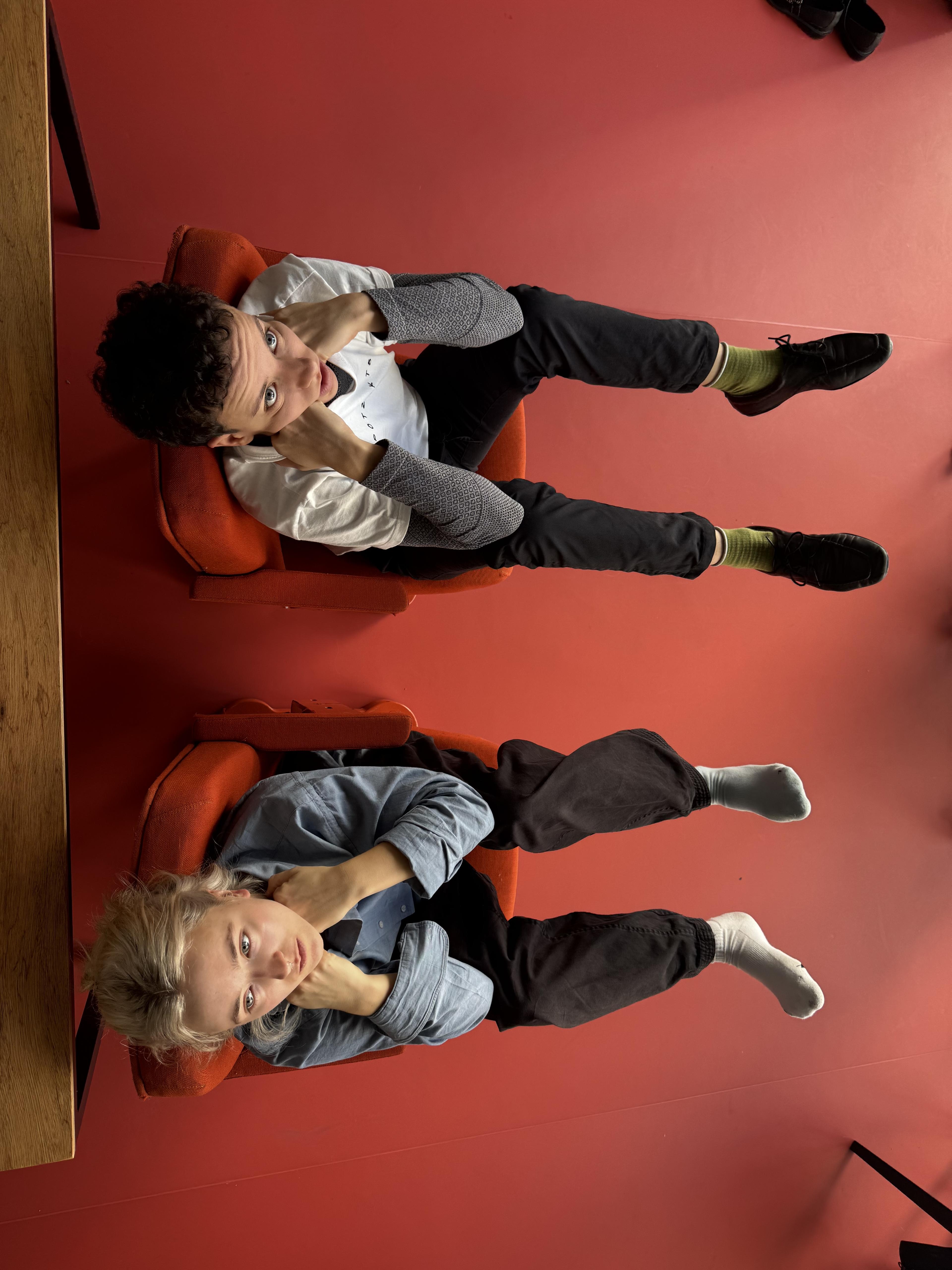 Fleur and Carla seated in the orange chairs