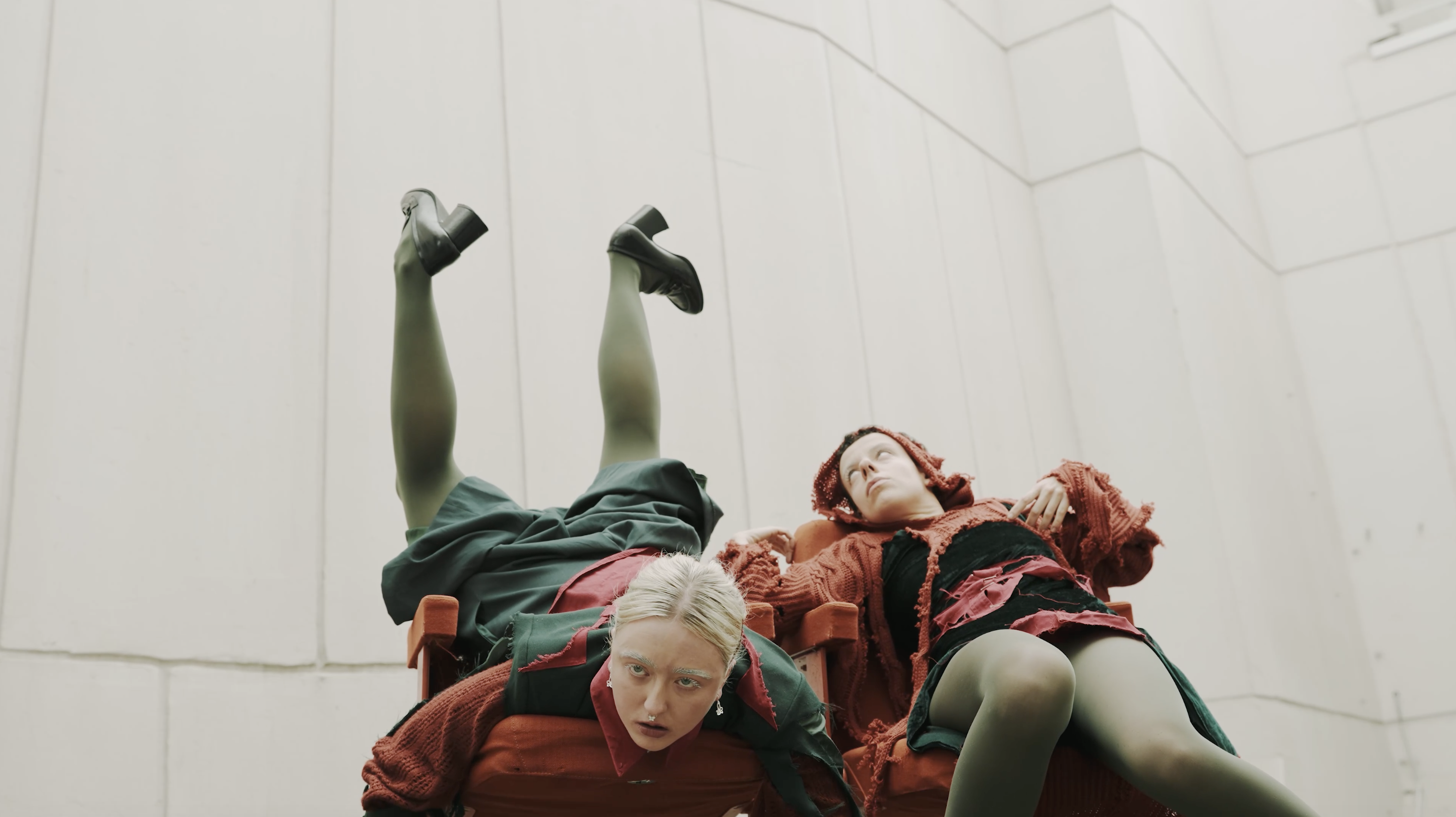 Fleur De Decker and Carla Parcianello seated in orange chairs