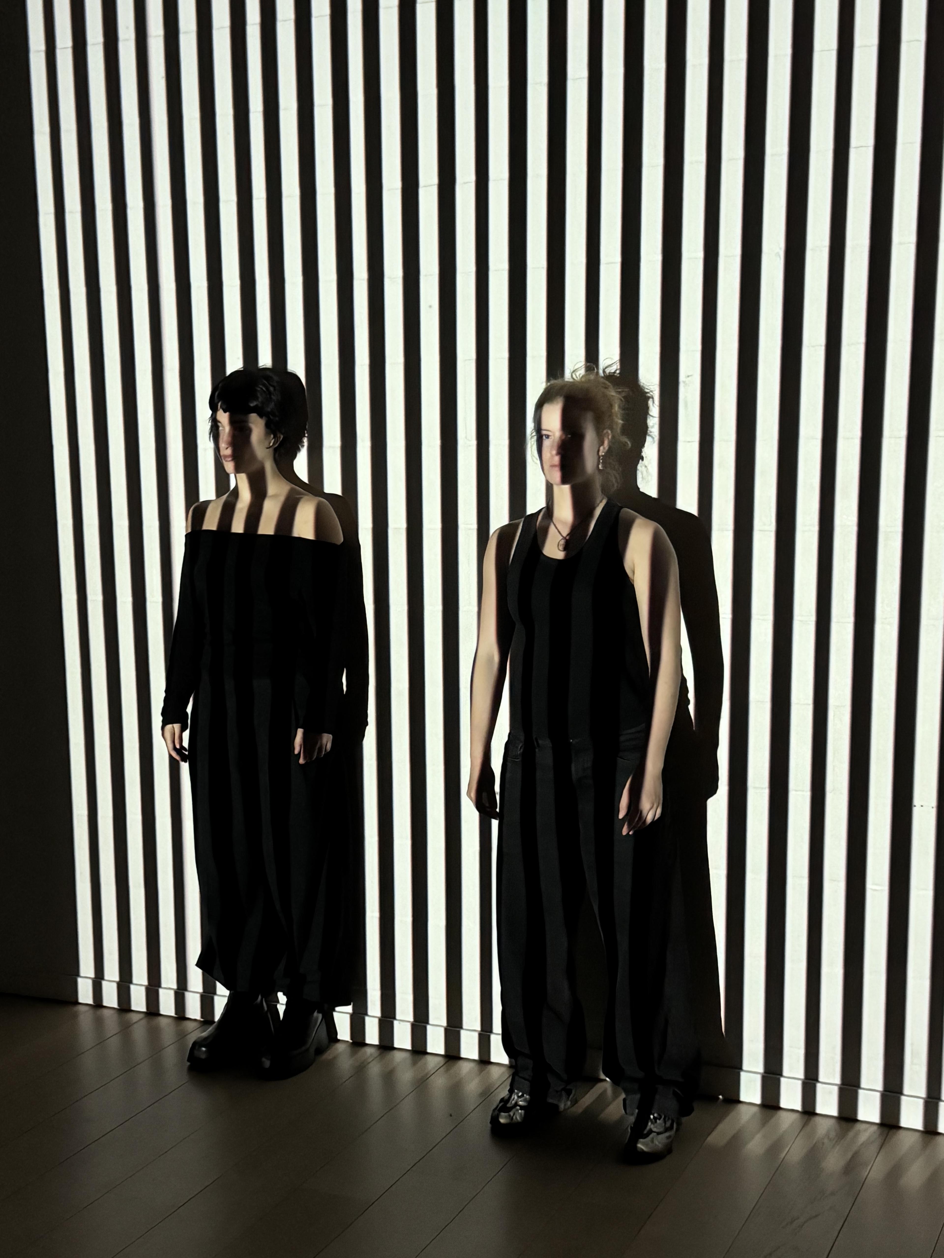 dancers illuminated by projected lines.
